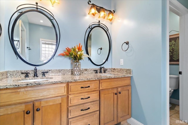 bathroom with tile patterned floors, vanity, and toilet