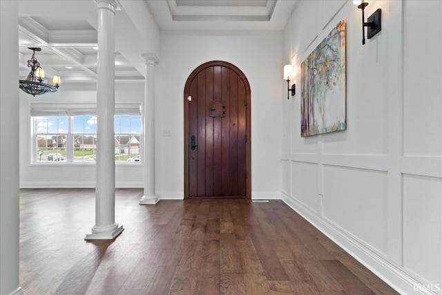 foyer entrance with beam ceiling, dark hardwood / wood-style flooring, ornate columns, and coffered ceiling