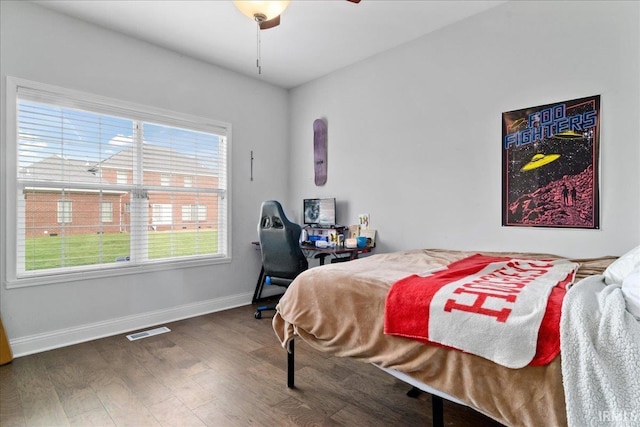 bedroom featuring ceiling fan and dark hardwood / wood-style flooring