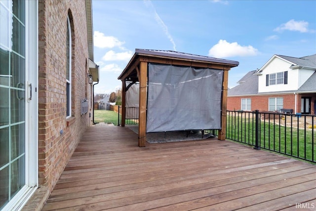 wooden deck featuring a yard