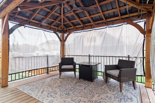 wooden terrace with a gazebo and ceiling fan