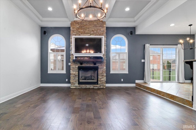 unfurnished living room with crown molding, a fireplace, a healthy amount of sunlight, and dark hardwood / wood-style floors