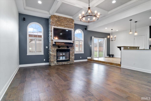 unfurnished living room featuring beamed ceiling, dark hardwood / wood-style floors, and a stone fireplace