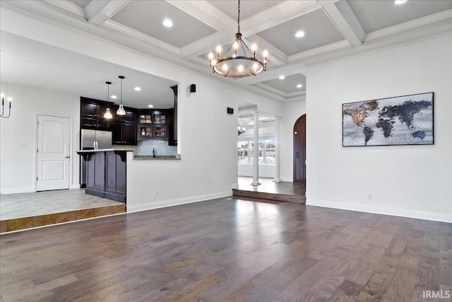 unfurnished living room with crown molding, dark wood-type flooring, and coffered ceiling