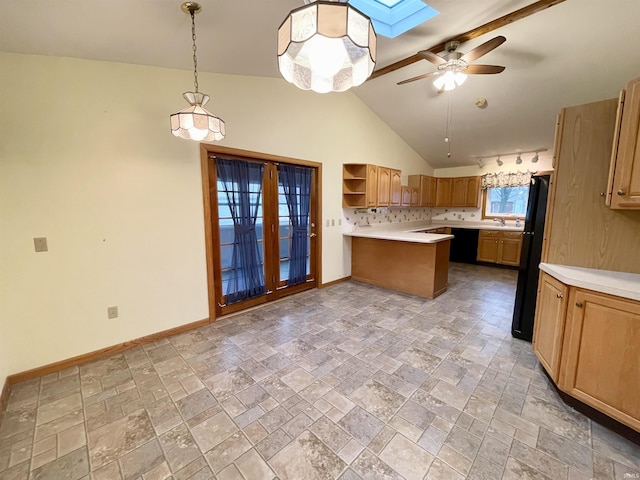 kitchen with ceiling fan, tasteful backsplash, black fridge, lofted ceiling with skylight, and decorative light fixtures