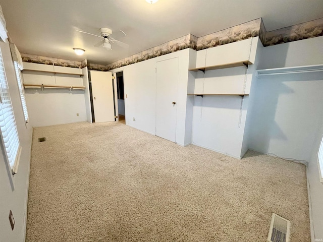 unfurnished bedroom with ceiling fan and light colored carpet