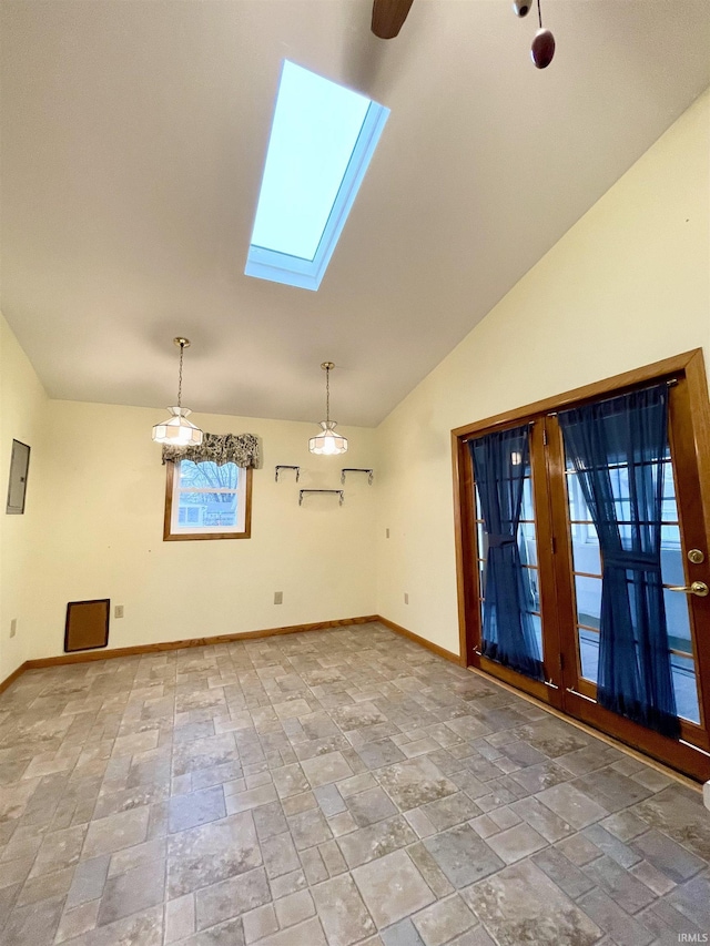 unfurnished room with vaulted ceiling with skylight and plenty of natural light