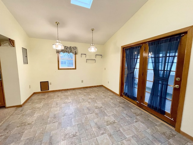 unfurnished dining area featuring electric panel and lofted ceiling