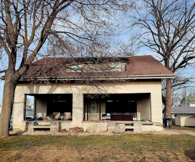 back of house with a yard and a porch