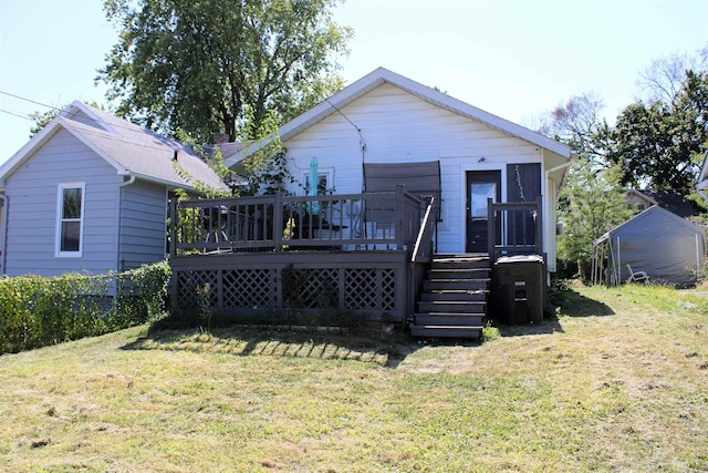 back of property with a lawn and a wooden deck