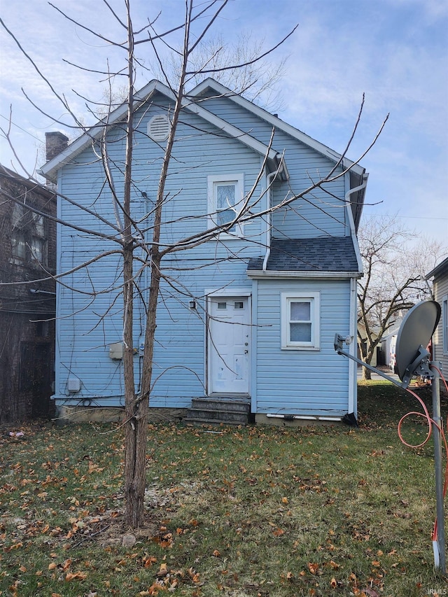 rear view of house with a lawn