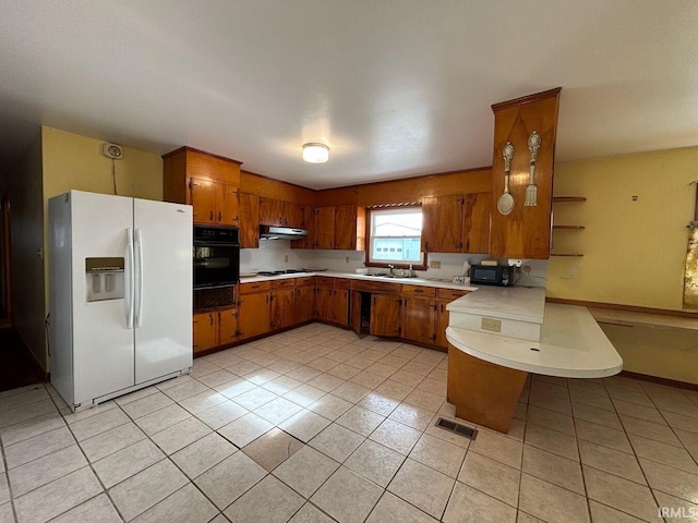 kitchen with sink, light tile patterned floors, and black appliances