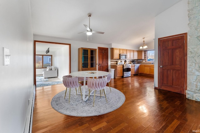 dining area with ceiling fan with notable chandelier, dark hardwood / wood-style floors, and baseboard heating