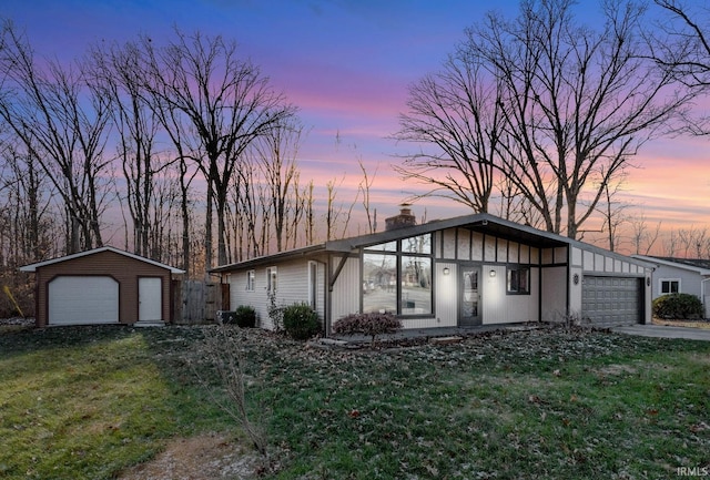 ranch-style house featuring a yard and a garage