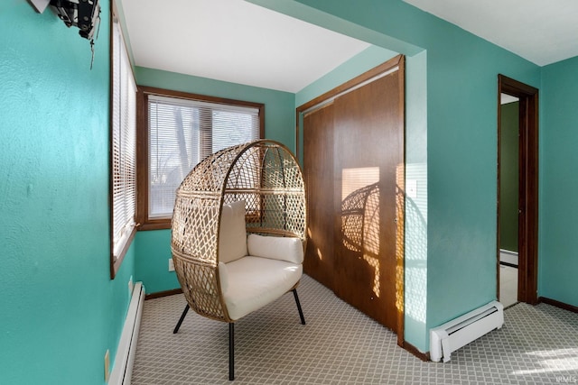 sitting room featuring light colored carpet and a baseboard radiator