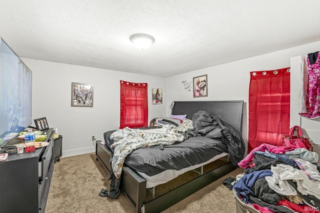 bedroom featuring a textured ceiling and carpet floors