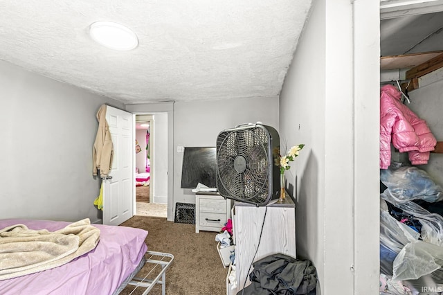 carpeted bedroom featuring a textured ceiling