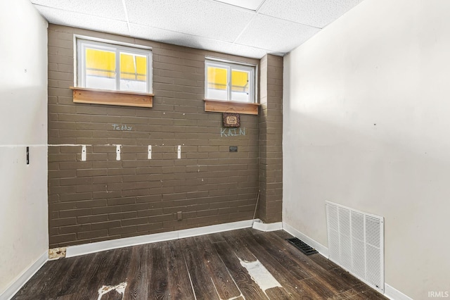 laundry area featuring a healthy amount of sunlight and dark hardwood / wood-style floors