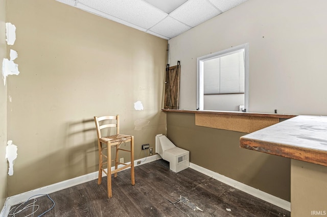 bathroom with hardwood / wood-style floors and a drop ceiling