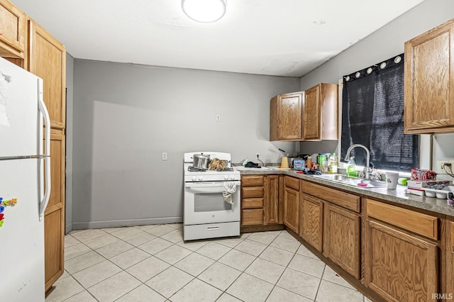 kitchen featuring sink, light tile patterned flooring, and white appliances