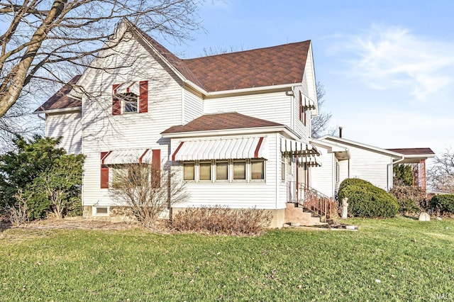 back of house with a lawn