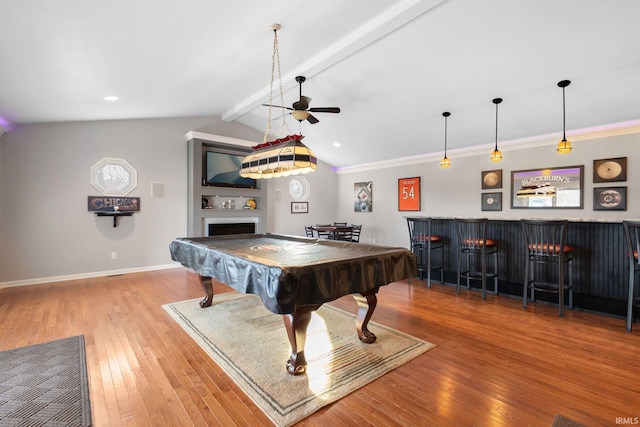 game room featuring lofted ceiling with beams, billiards, indoor bar, light hardwood / wood-style flooring, and ornamental molding