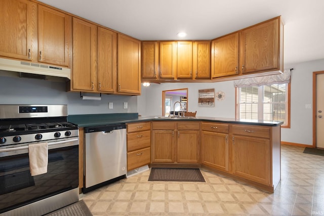 kitchen featuring kitchen peninsula, sink, and appliances with stainless steel finishes