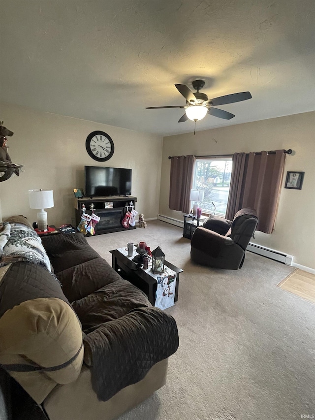 carpeted living room with ceiling fan, a textured ceiling, and a baseboard heating unit