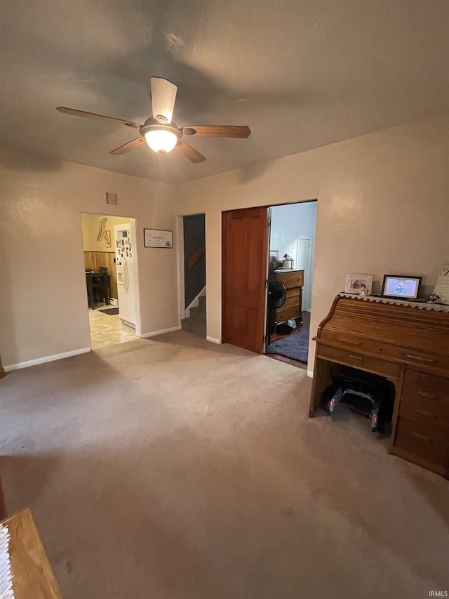 interior space with ceiling fan and light colored carpet