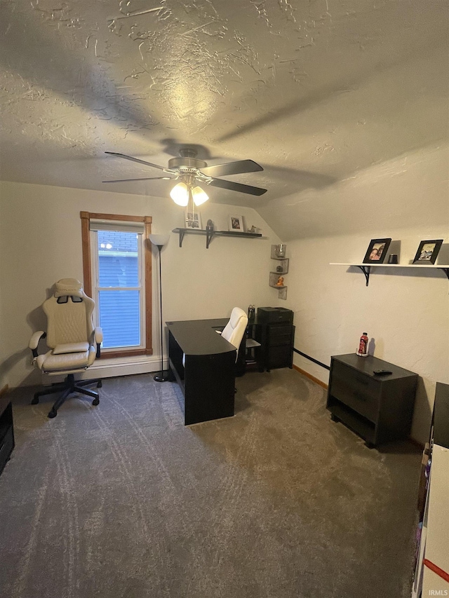 home office featuring a textured ceiling, dark carpet, ceiling fan, and lofted ceiling