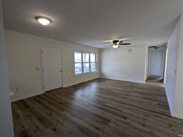 foyer entrance with ceiling fan and dark wood-type flooring