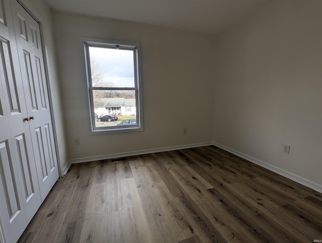 unfurnished bedroom featuring dark hardwood / wood-style flooring