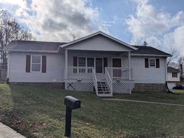 view of front of home with covered porch and a front lawn