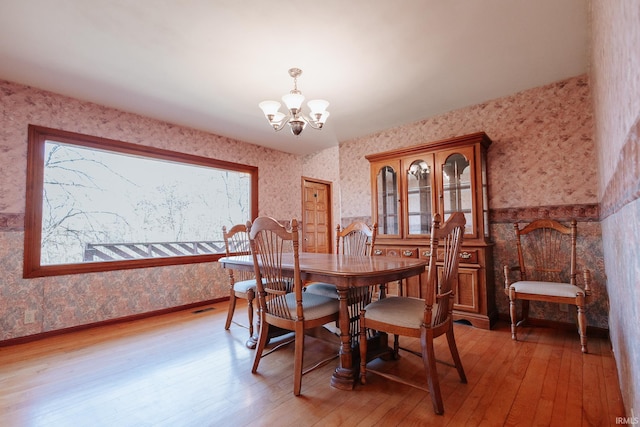 dining area featuring a chandelier and light hardwood / wood-style floors