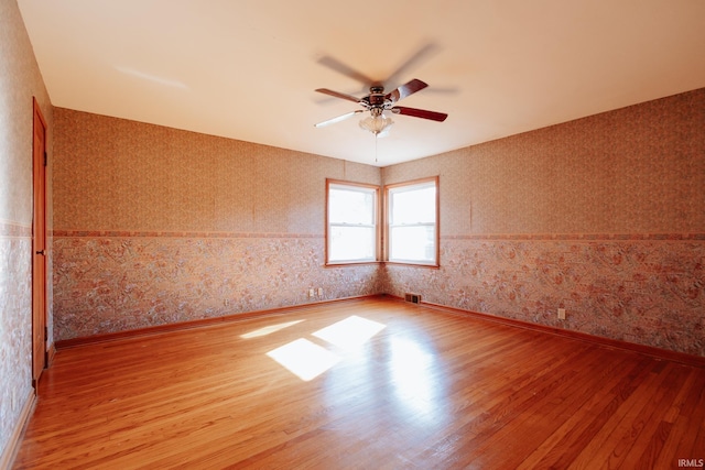 empty room with light hardwood / wood-style floors and ceiling fan