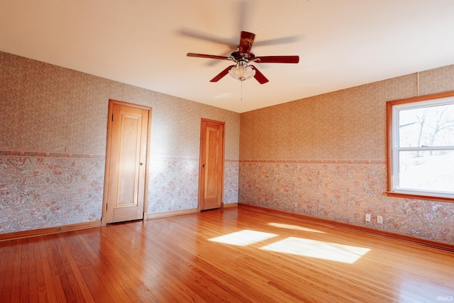 unfurnished room with ceiling fan and hardwood / wood-style flooring