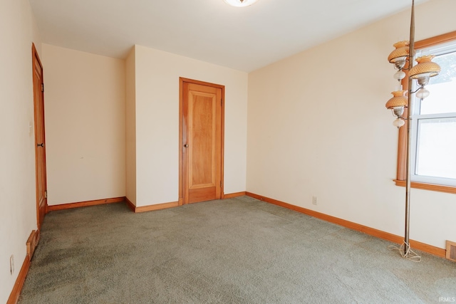 carpeted spare room with a healthy amount of sunlight