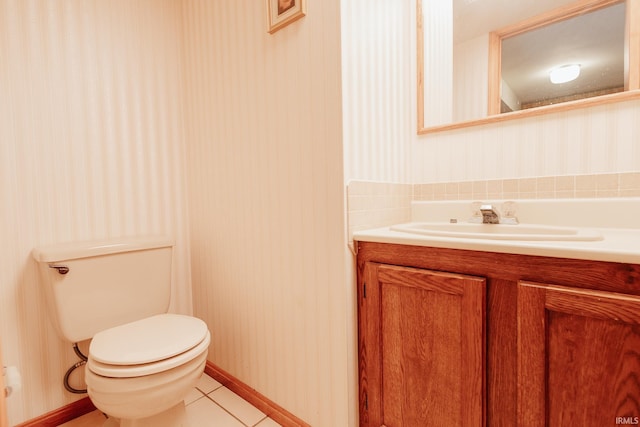 bathroom with tile patterned flooring, vanity, and toilet