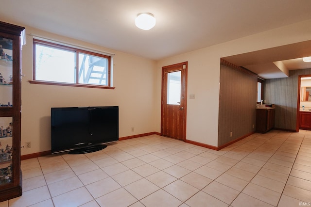 entryway featuring wooden walls and light tile patterned flooring