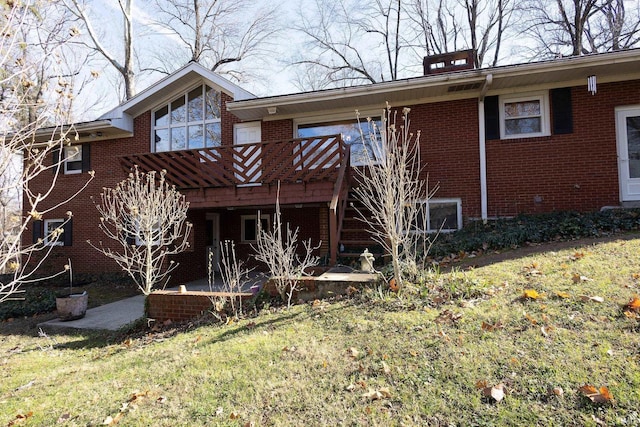 back of property featuring a lawn, a patio area, and a deck