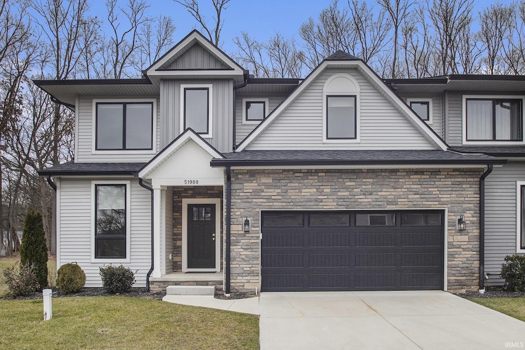 view of front of property featuring a garage and a front lawn