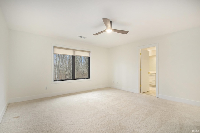 carpeted spare room featuring ceiling fan