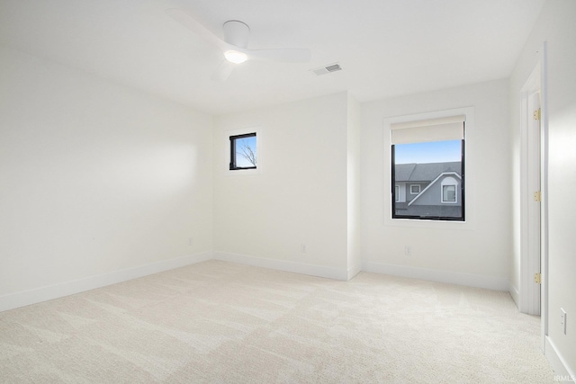 carpeted spare room with ceiling fan