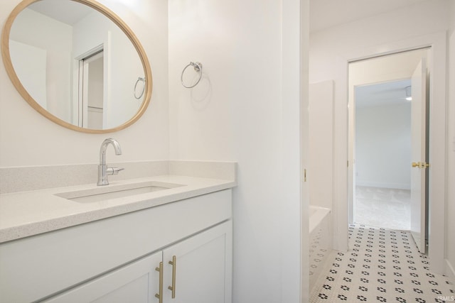 bathroom with vanity and a tub