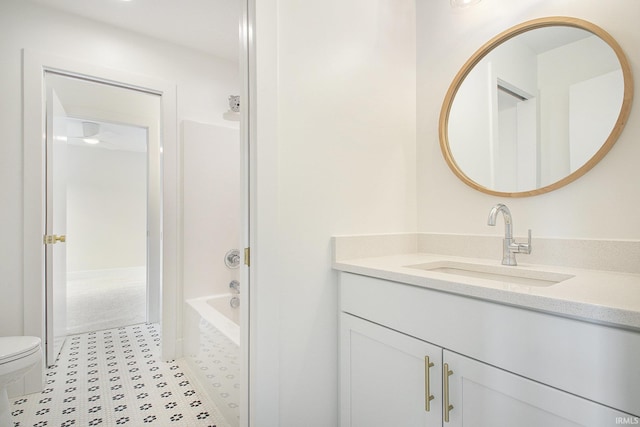 full bathroom with tile patterned floors, vanity, toilet, and washtub / shower combination