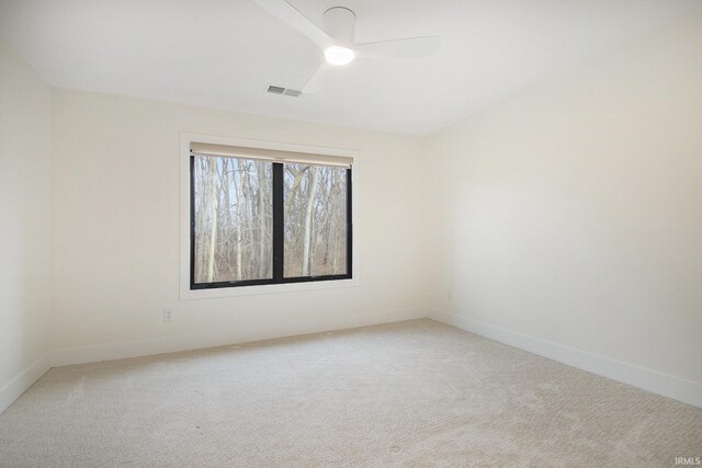 carpeted empty room featuring ceiling fan