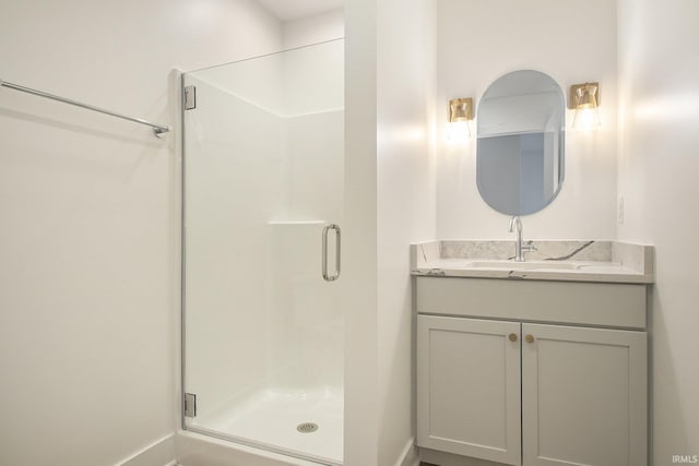 bathroom with vanity and a shower with shower door