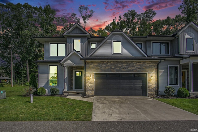 view of front of property with a lawn and a garage