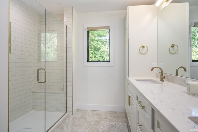 bathroom with vanity and a shower with door