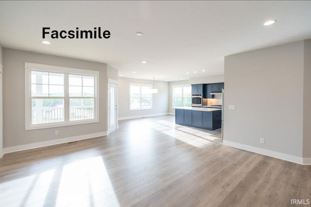 unfurnished living room featuring light wood-type flooring